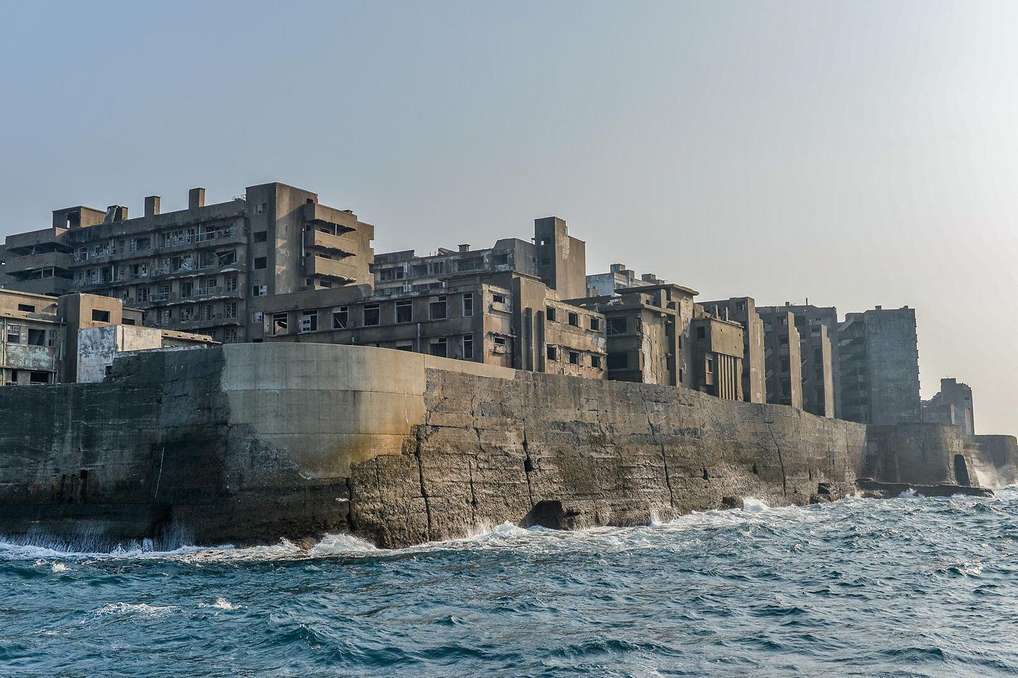 Hashima Island’s abandoned concrete buildings rise over the sea. - Nagasaki, Japan