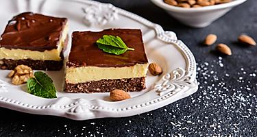 A white plate with two Nanaimo bars