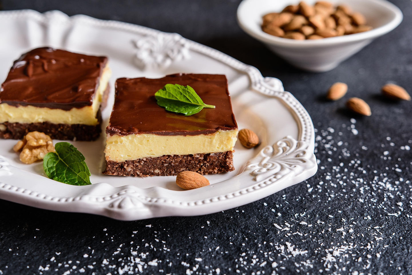 Classic Nanaimo bars stacked on plate with chocolate topping. - Victoria, British Columbia