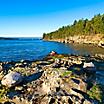 A rocky coastline bordered with lush vegetation in Nanaimo, British Columbia