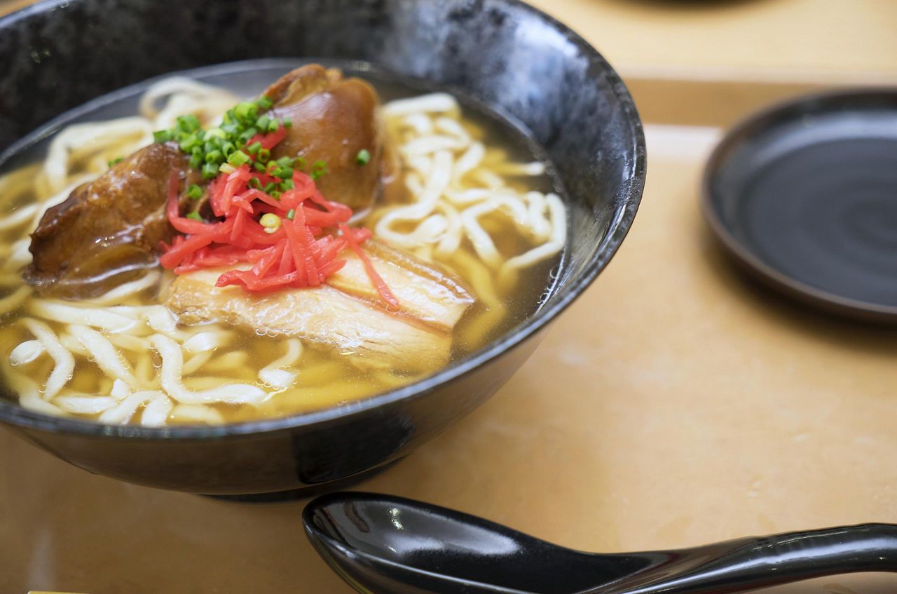 Bowl of Okinawa Soba Soup with thick noodles in Okinawa, Japan