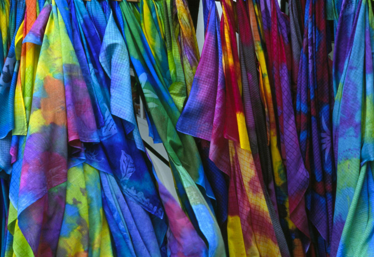Closeup of colorful Pareus hanging on store rack in Tahiti