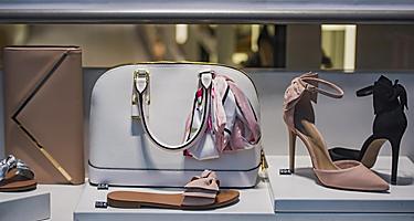 A typical designer storefront in Paris, France displaying shoes and handbags