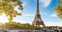 View of the Eiffel tower from the water with boats in Paris. Europe.
