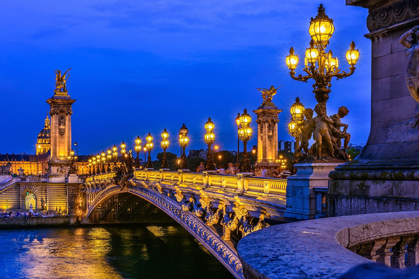 Pont Alexandre III’s ornate lamps and arches span the Seine. - Paris, France
