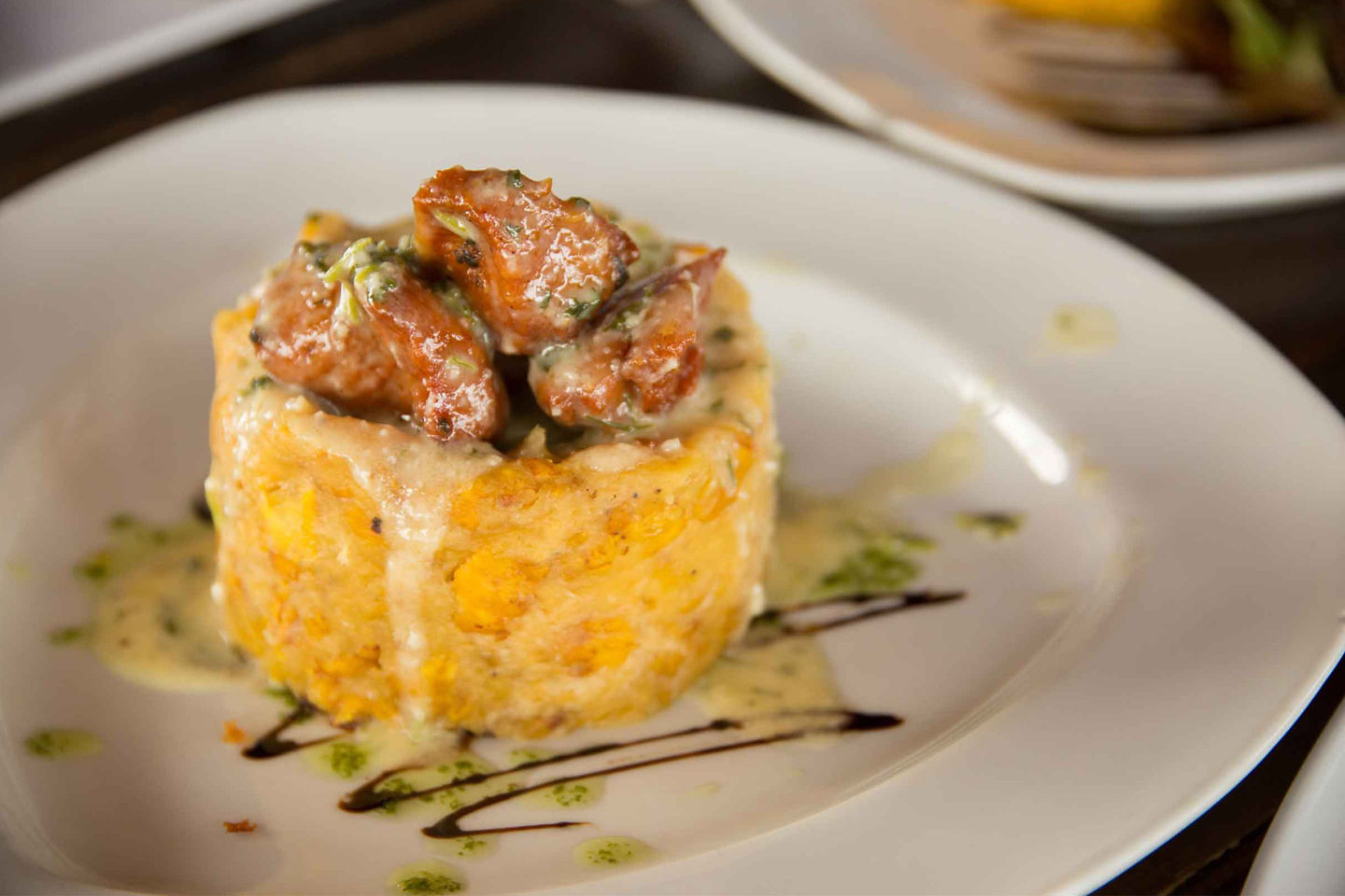 Mofongo served on a plate with local ingredients and garnishes. - San Juan, Puerto Rico