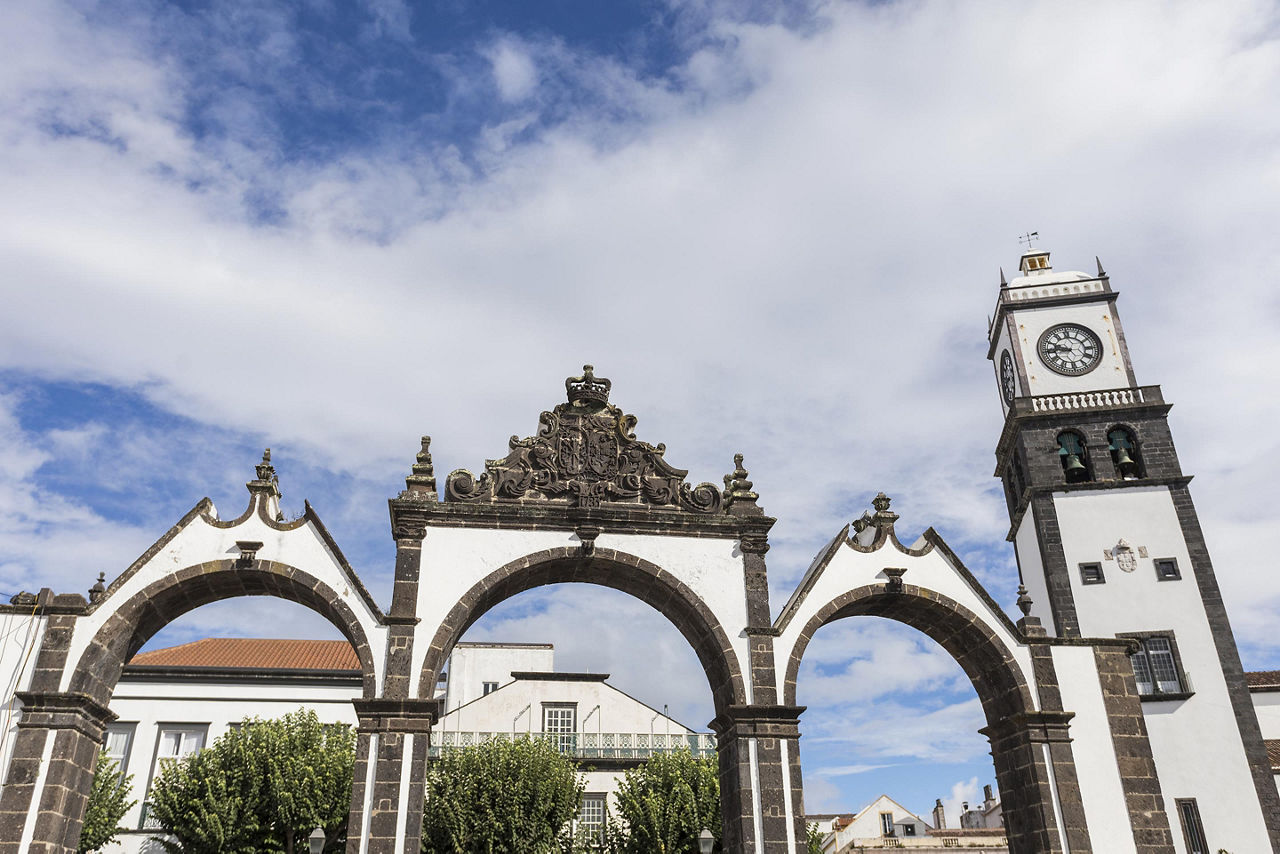 Portas de Cidade and the Saint Sebastian church clock tower in Ponta Delgada, Azores