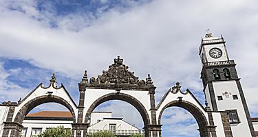 Portas de Cidade and the Saint Sebastian church clock tower in Ponta Delgada, Azores