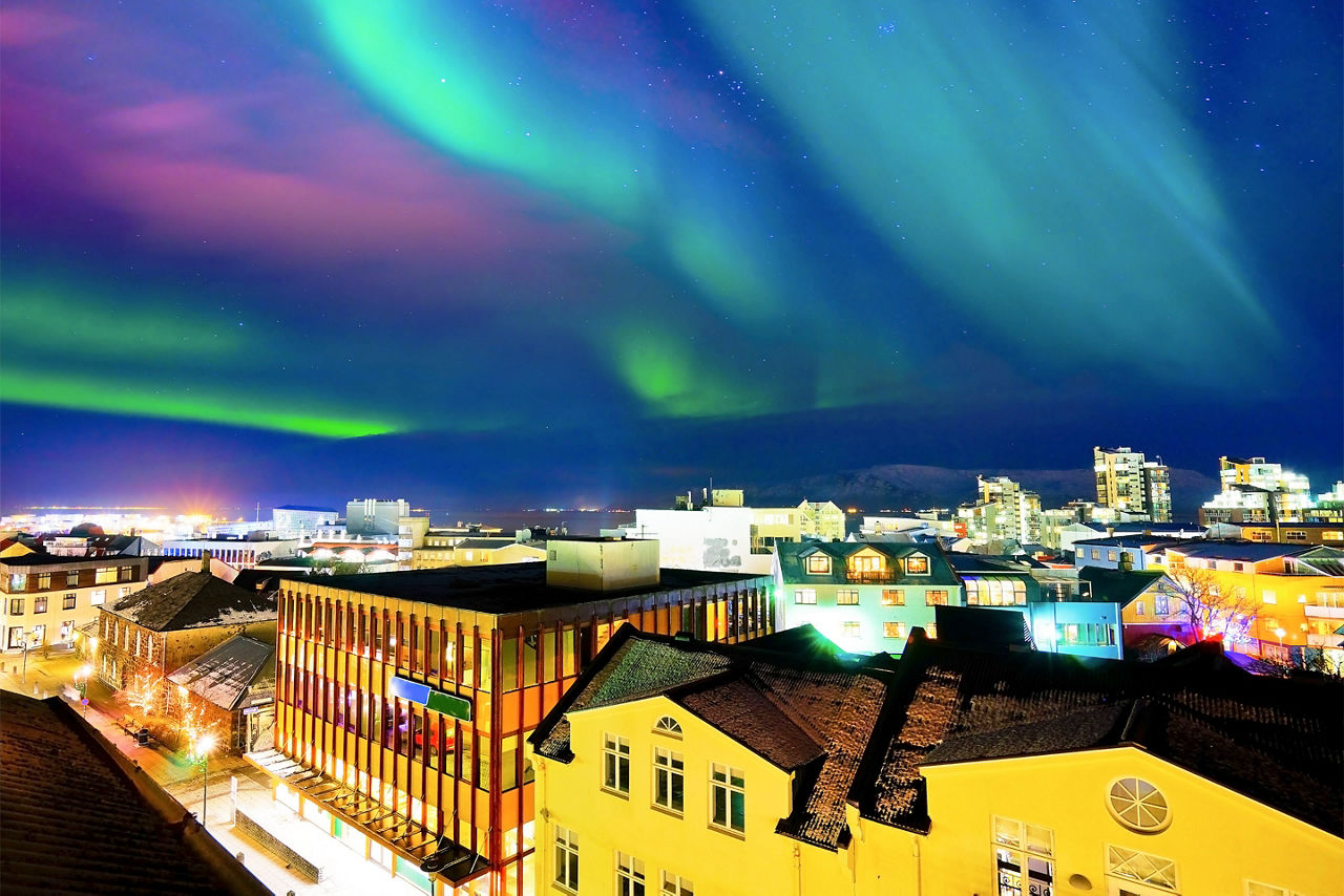 View of the northern lights from the city center in Reykjavik. Iceland.