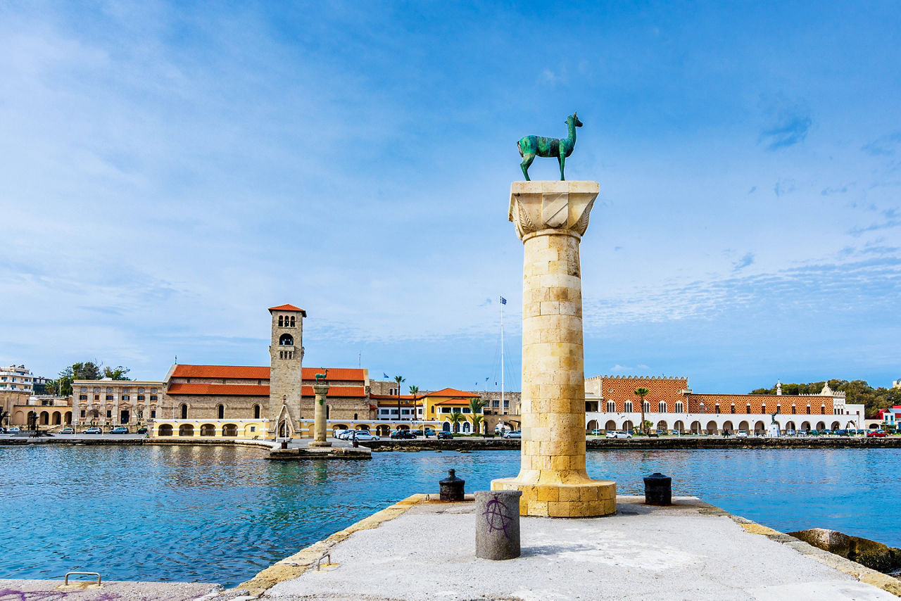 Mandraki port with deers statue, where The Colossus was standing and fort of St. Nicholas. Rhodes, Greece