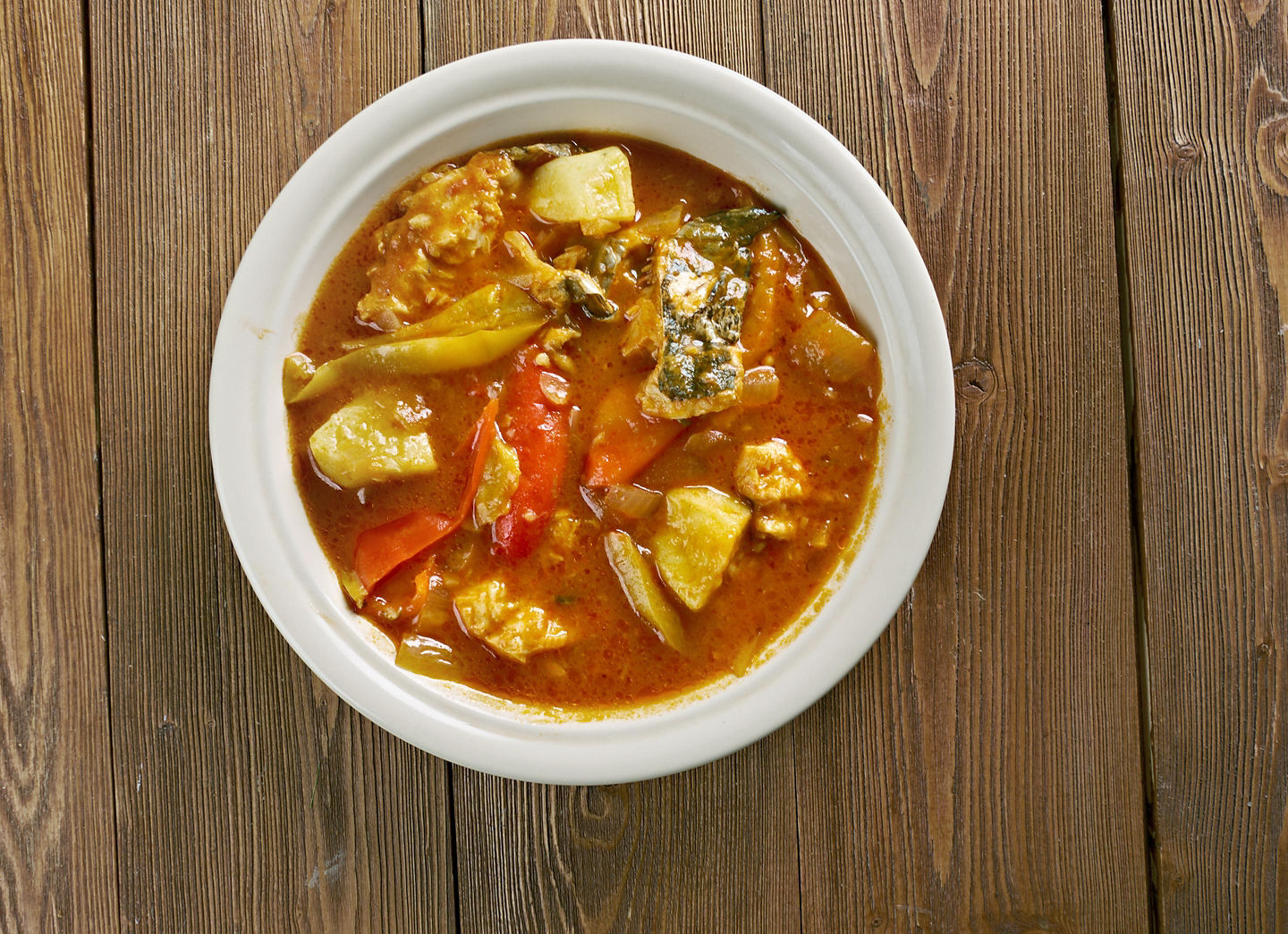 Creamy conch soup blends tender conch, coconut milk, vegetables, and spices. - Roatán, Honduras
