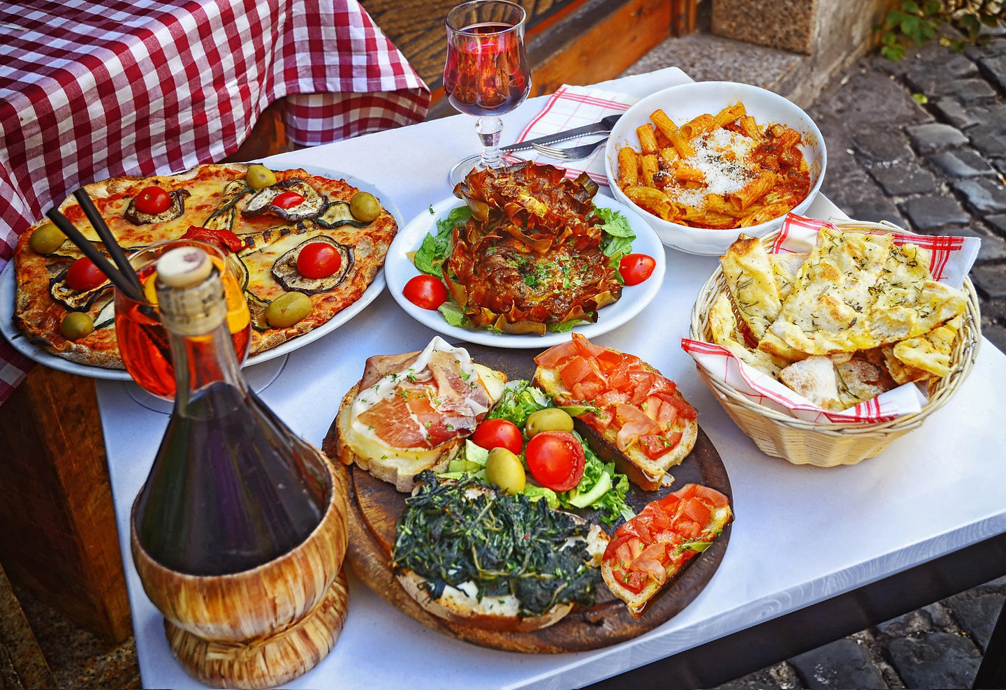 A rustic Roman pizza and pasta spread shows classic Italian flavors in a simple, hearty style. - Rome, Italy