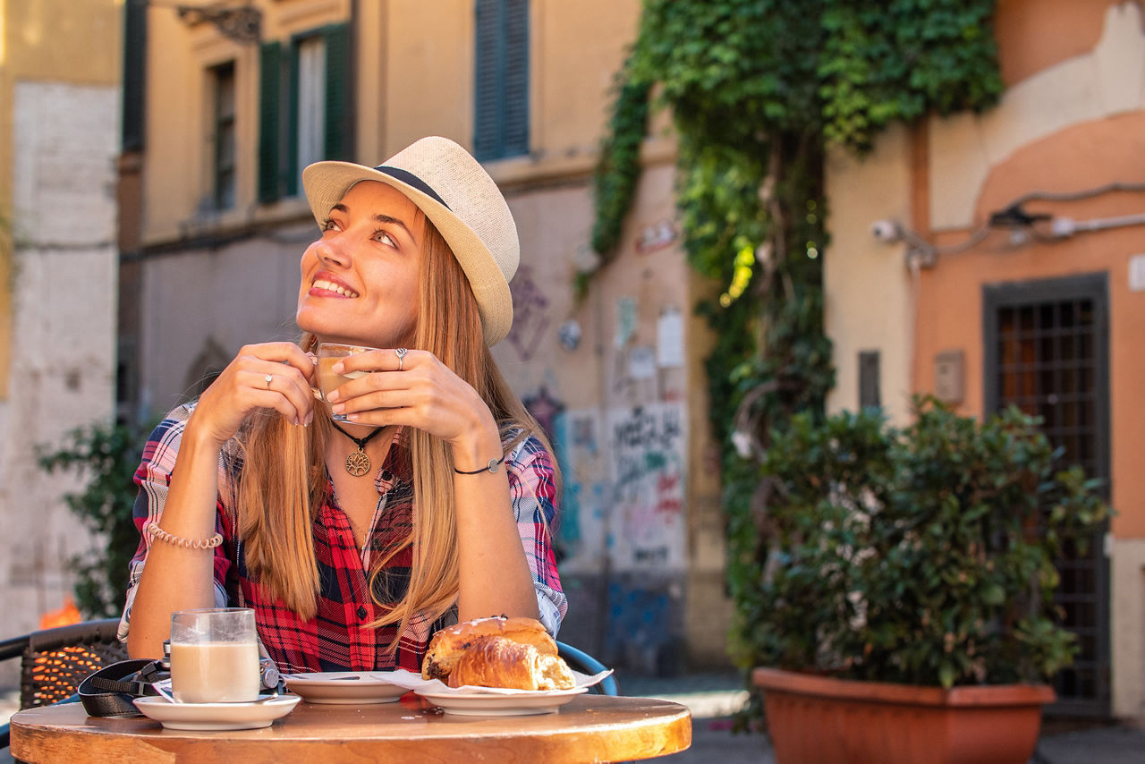 Young Woman having Breakfast Espresso in the streets of Rome