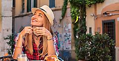 Young Woman having Breakfast Espresso in the streets of Rome