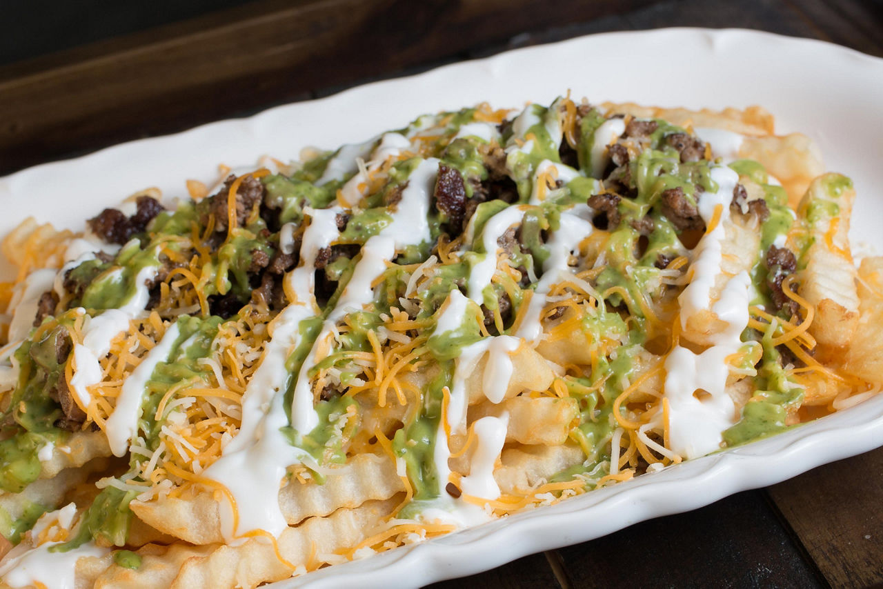 Fries with cheese, guacamole, and carne asada, in San Diego, California
