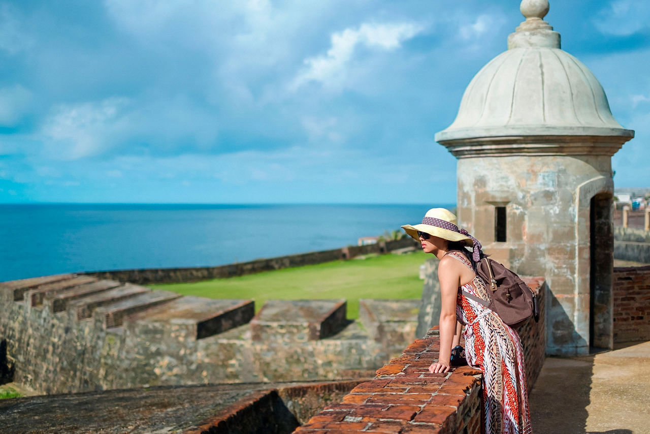 Woman Leaning on Fort El Morro to Enjoy the view, San Juan, Puerto Rico
