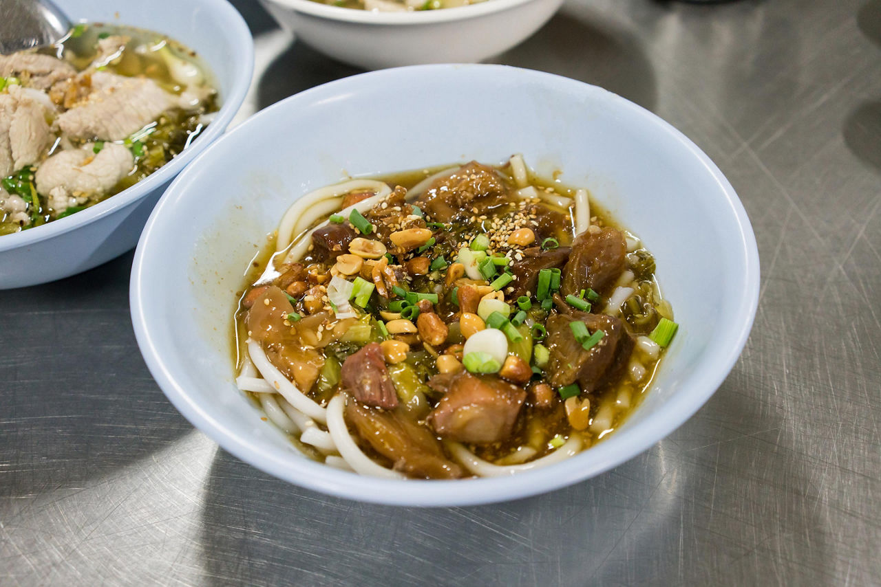A bowl of rice noodle with braised beef
