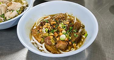 A bowl of rice noodle with braised beef