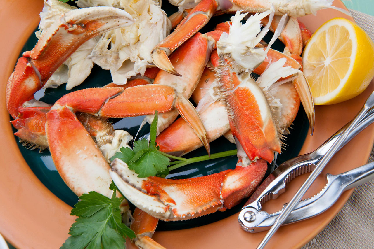 Assorted Dungeness crab legs with butter mustard sauce and fresh lemons in Seattle, Washington