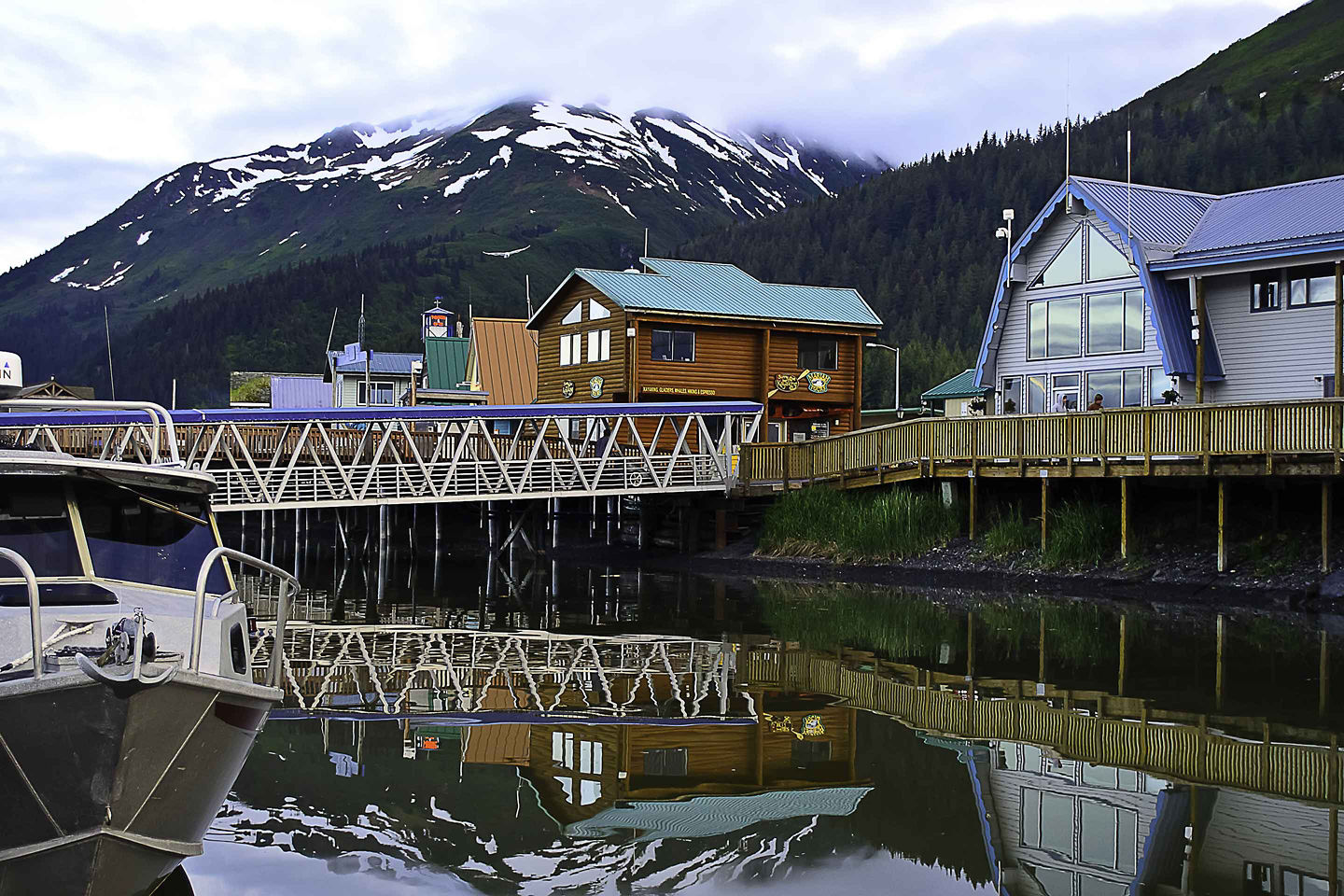 Seward’s coastal main street features colorful shops, mountain views, and a calm waterfront atmosphere. - Seward, Alaska