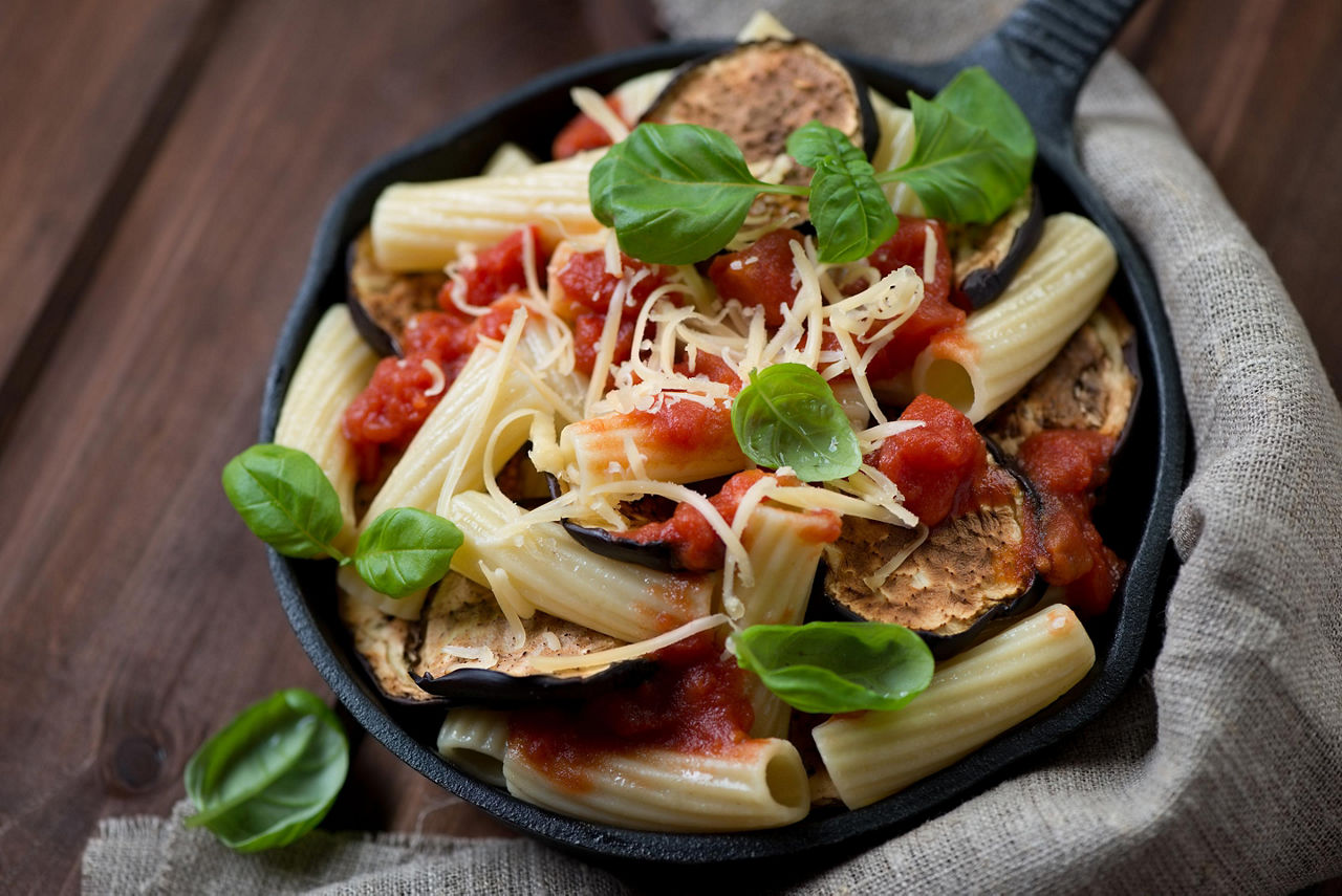 A bowl of pasta alla norma with eggplant and tomato
