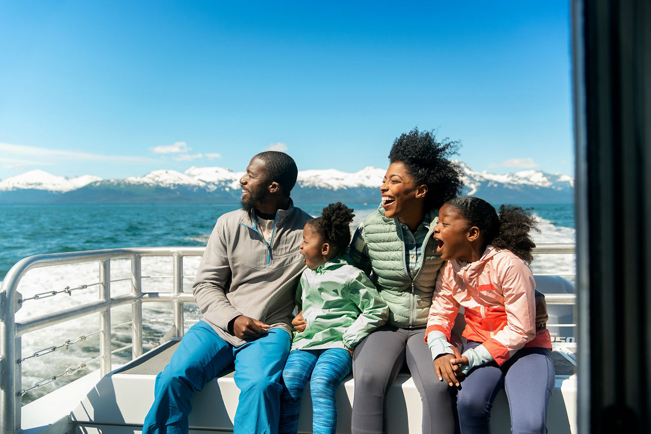 Family watching out for whales on an Alaskan Cruise