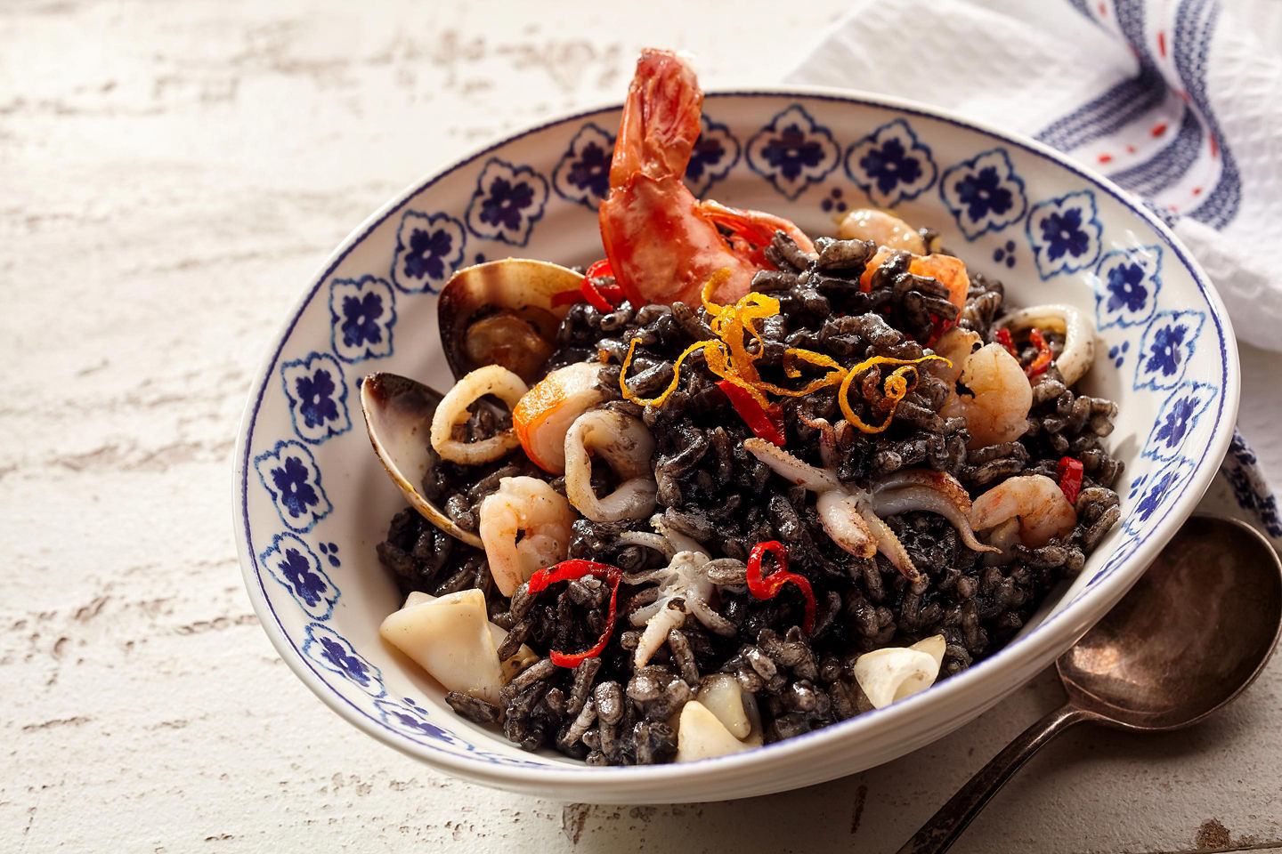 Black seafood risotto from Split is served with tender squid and rich, savory ink. - Split, Croatia