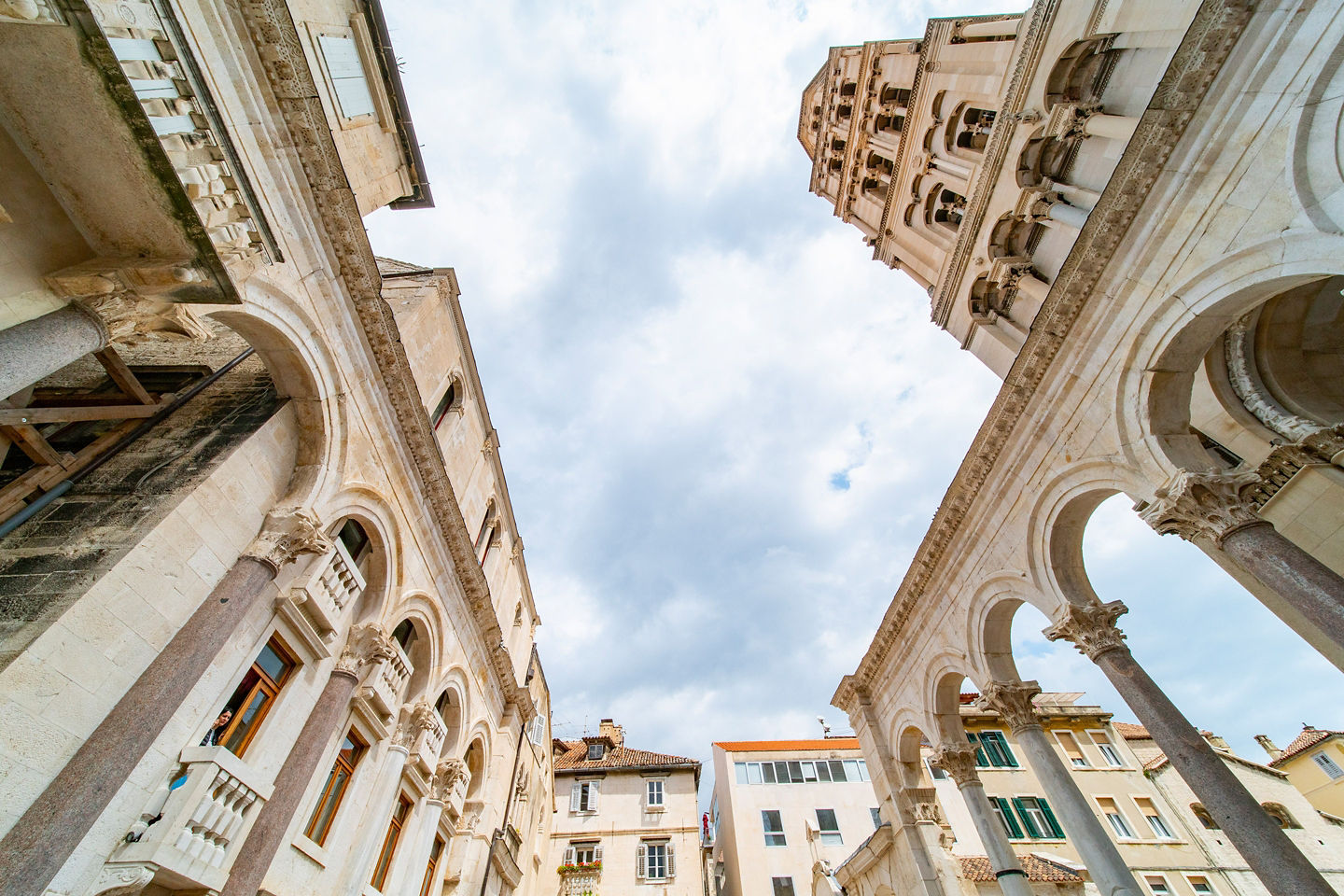 Close‑up of Diocletian’s Palace stone arches showing detailed carvings and weathered ancient masonry. - Split, Croatia