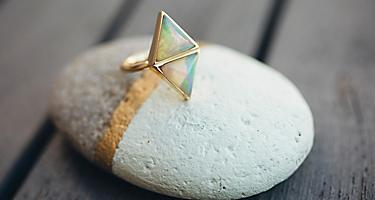 An opal ring displayed on a stone