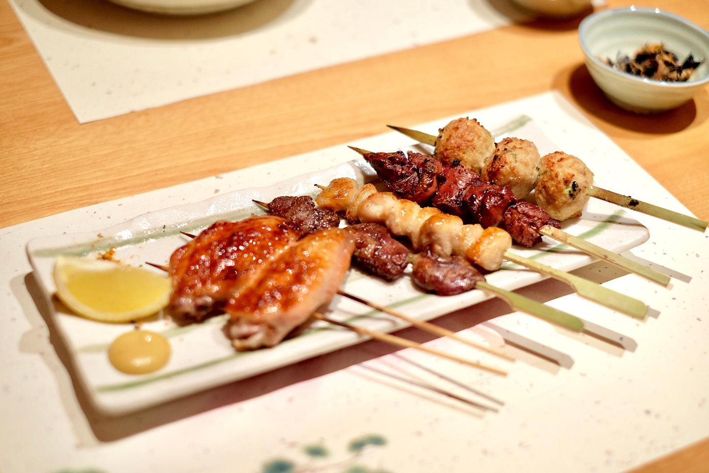 Chicken yakitori on a white plate.