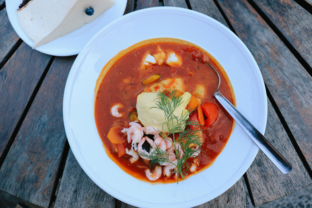 A bowl of fish soup with potatoes in a tomato paste in Sweden