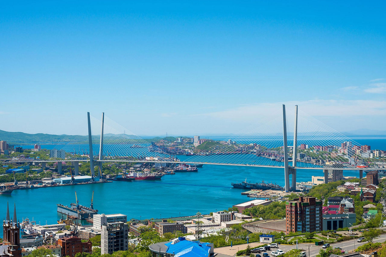 Day time cityscape of Vladivostok, Russia, with Zolotoy Golden Bridge in the background