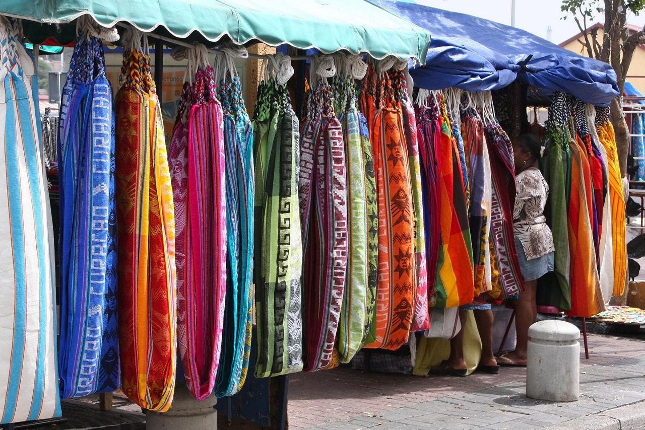An assortment of dresses for sale at a market