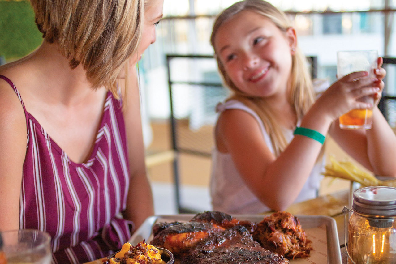 Oasis of the Seas Portside BBQ Mom Daughter Eating Chicken