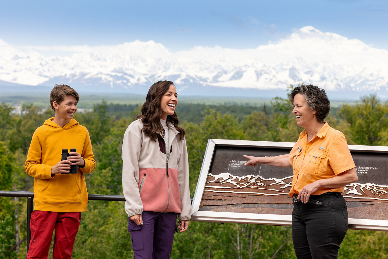 Family at view point looking at mountains at the Talkeetna Alaskan Lodge