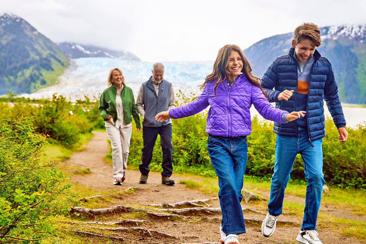 Family walking on a trail at Taku Glacier Lodge 