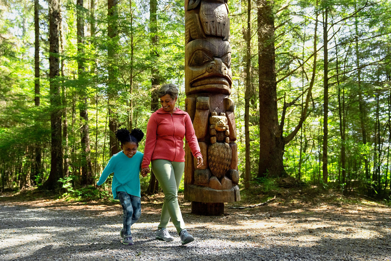 Mom and daughter walking in forest, Alaska, Stitka