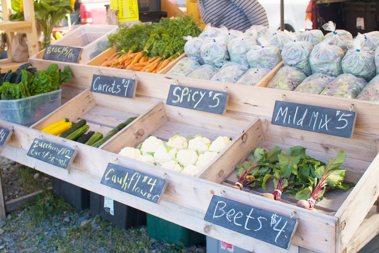 Vegetables on display at a local farmers market in Homer, Alaska with chalkboard labels