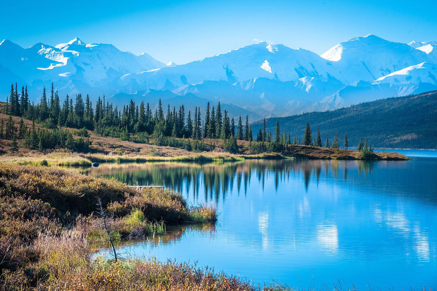 Mountain lake beneath Denali’s towering snow‑covered peaks. - Denali National Park, Alaska