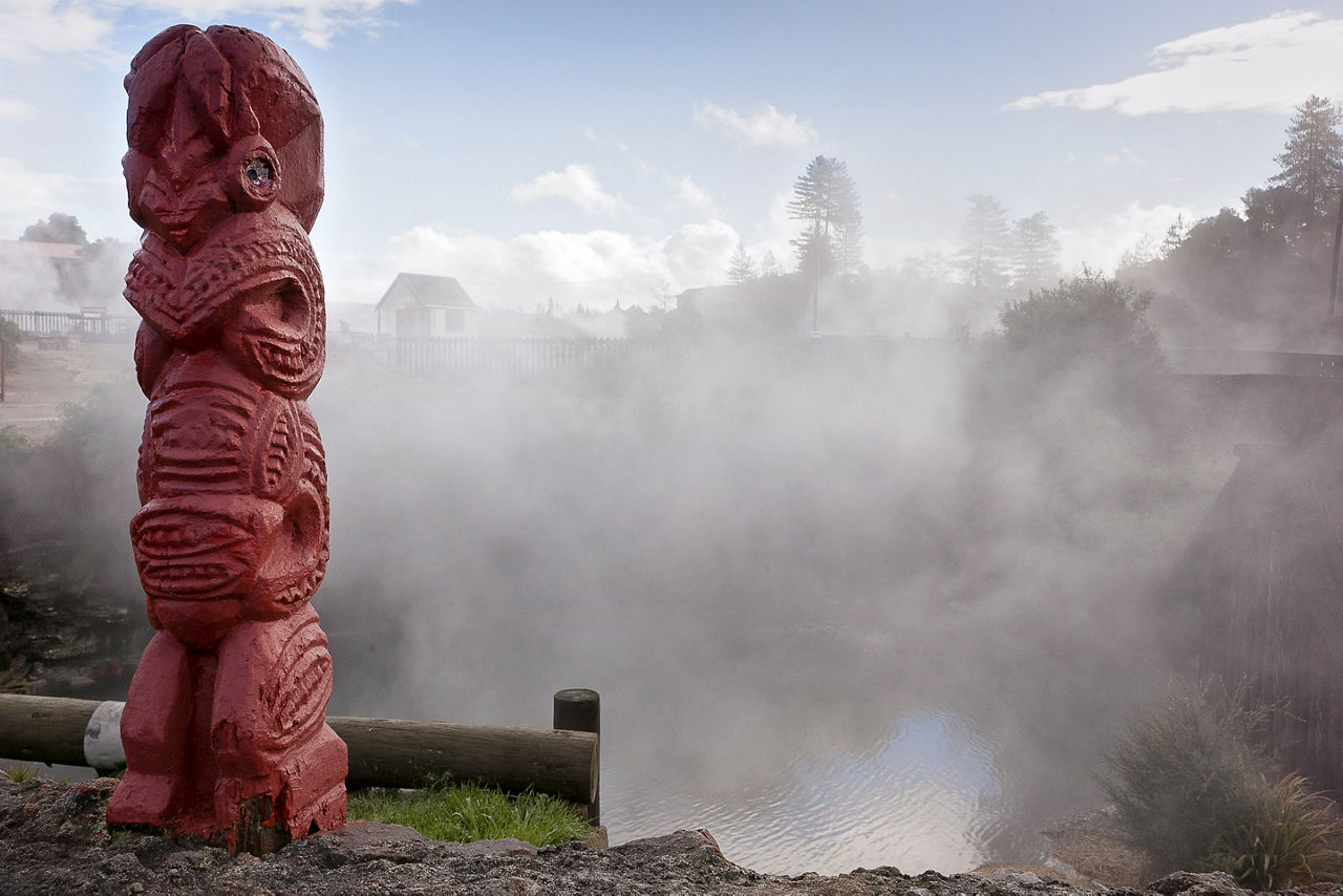 Maori Totem standing in front of hot spring. Australia