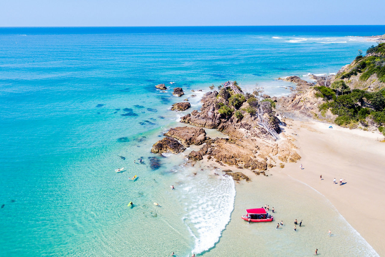 The Pass and Wategoes at Byron Bay from an aerial view with blue water