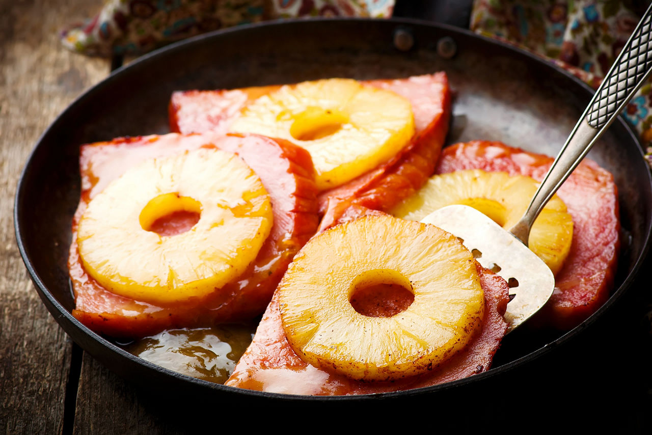 Ham with Pineapple in iron pan.selective focus.style rustic
