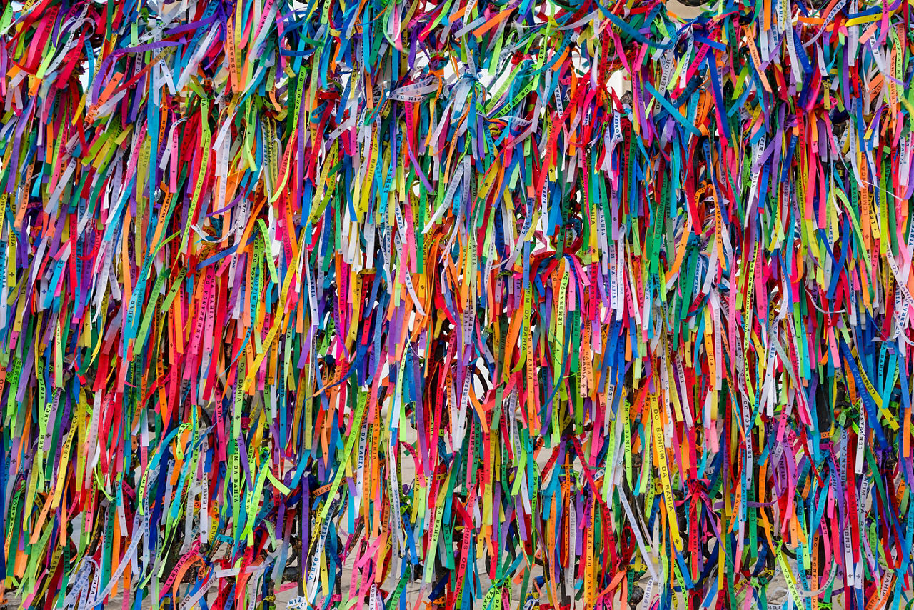 Colorful Brazilian Carnival festival wish ribbons hung at a church in Salvador, Brazil.