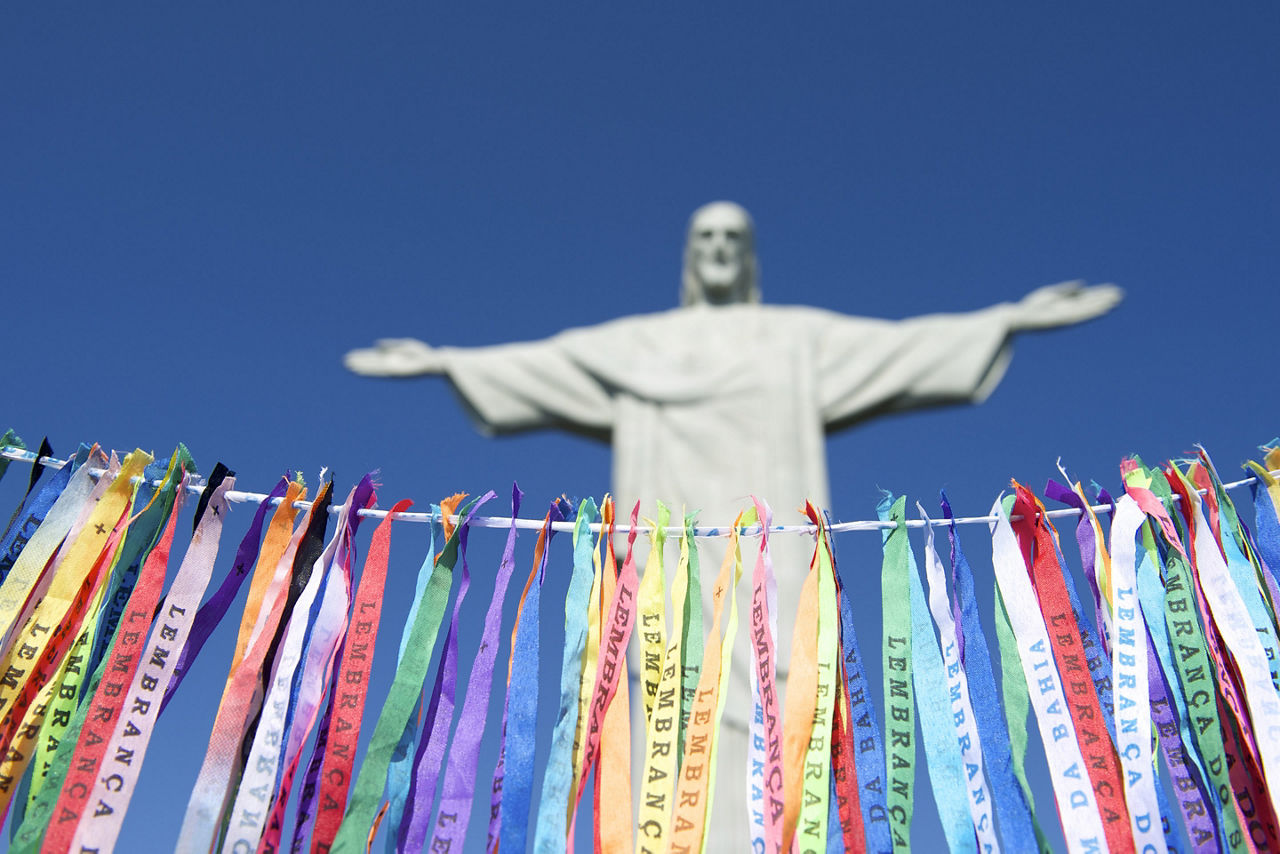 Christ the Redeemer statue in view behind Rio Carnival ribbons. Brazil.