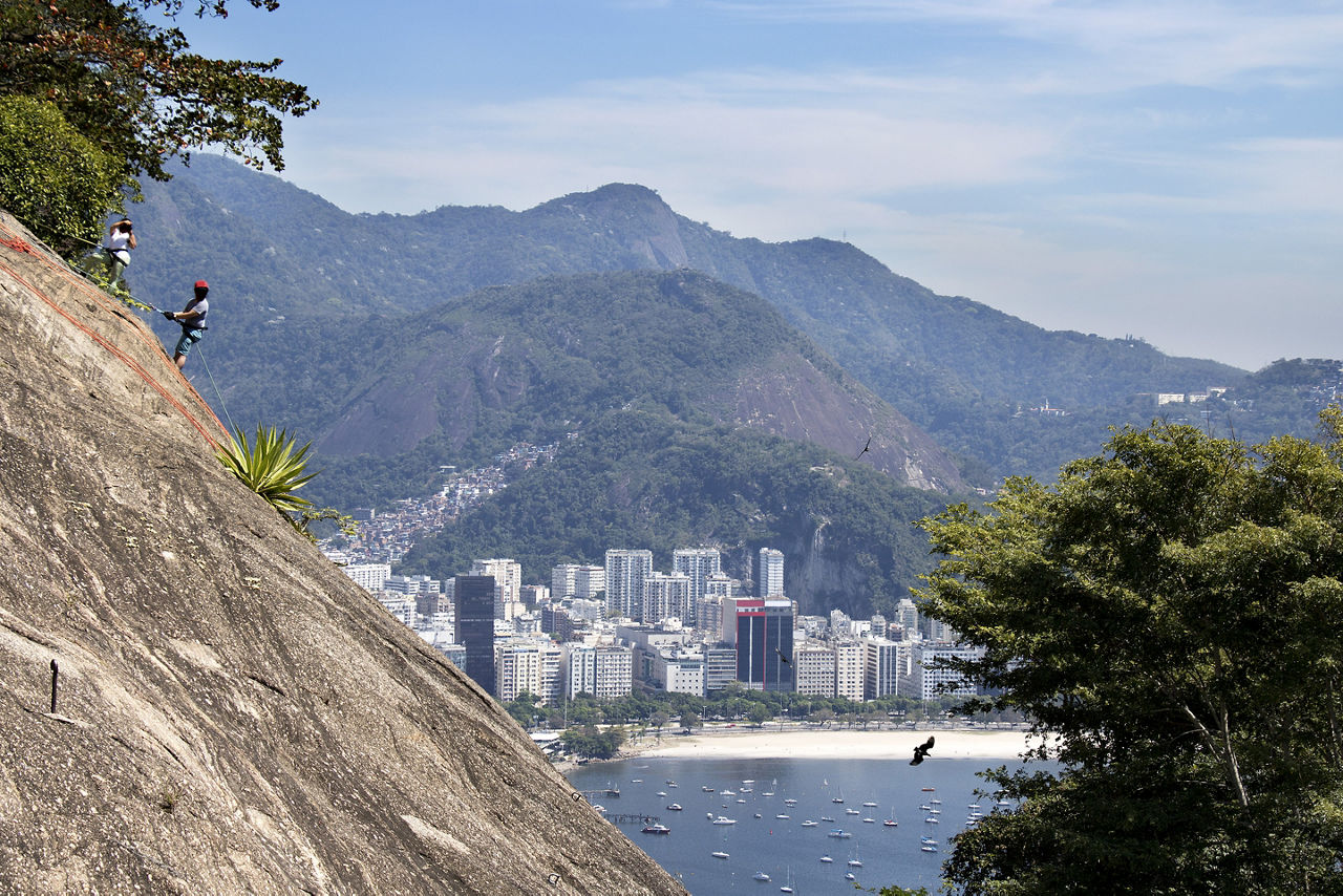 Vacation travelers climbing the rocks at Rio de Janeiro on Sugarloaf Mountain. Brazil.