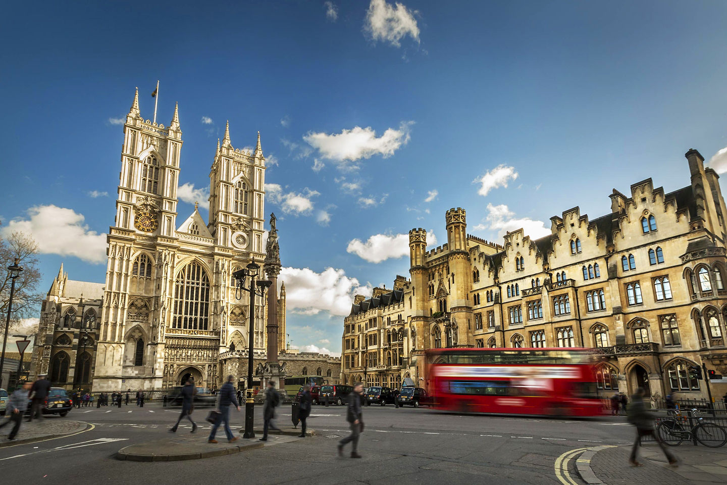 Westminster Abbey’s intricate Gothic façade rises above the street. - London, England