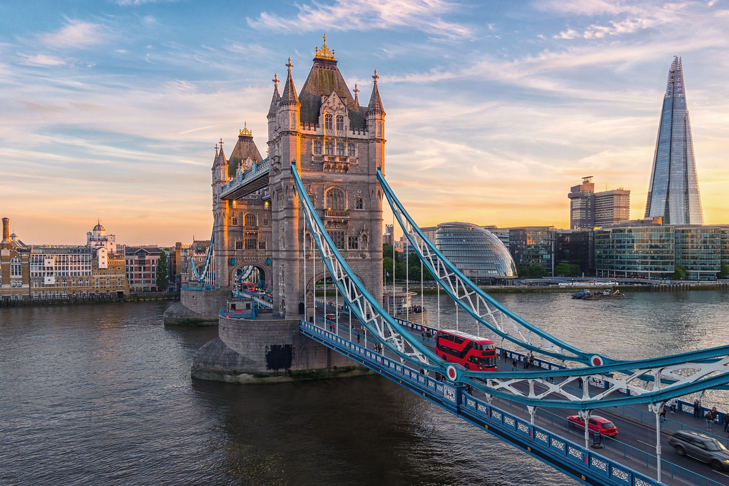 Tower Bridge spans the Thames as its twin towers rise against clear London daylight. - London, England
