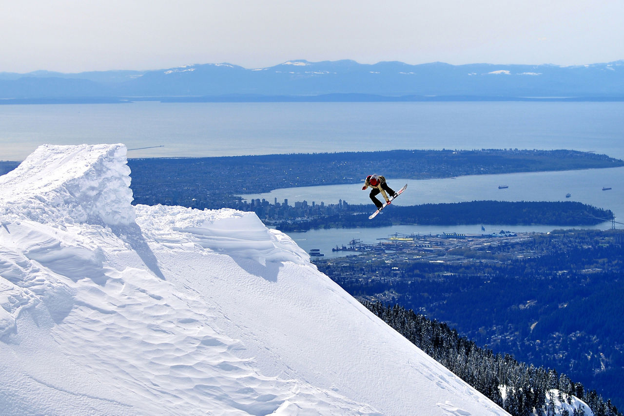 Snowboarder launching of a jump. Canada.