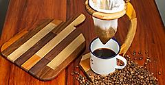 Wooden drip coffee machine with beans and cutting board. Costa Rica.