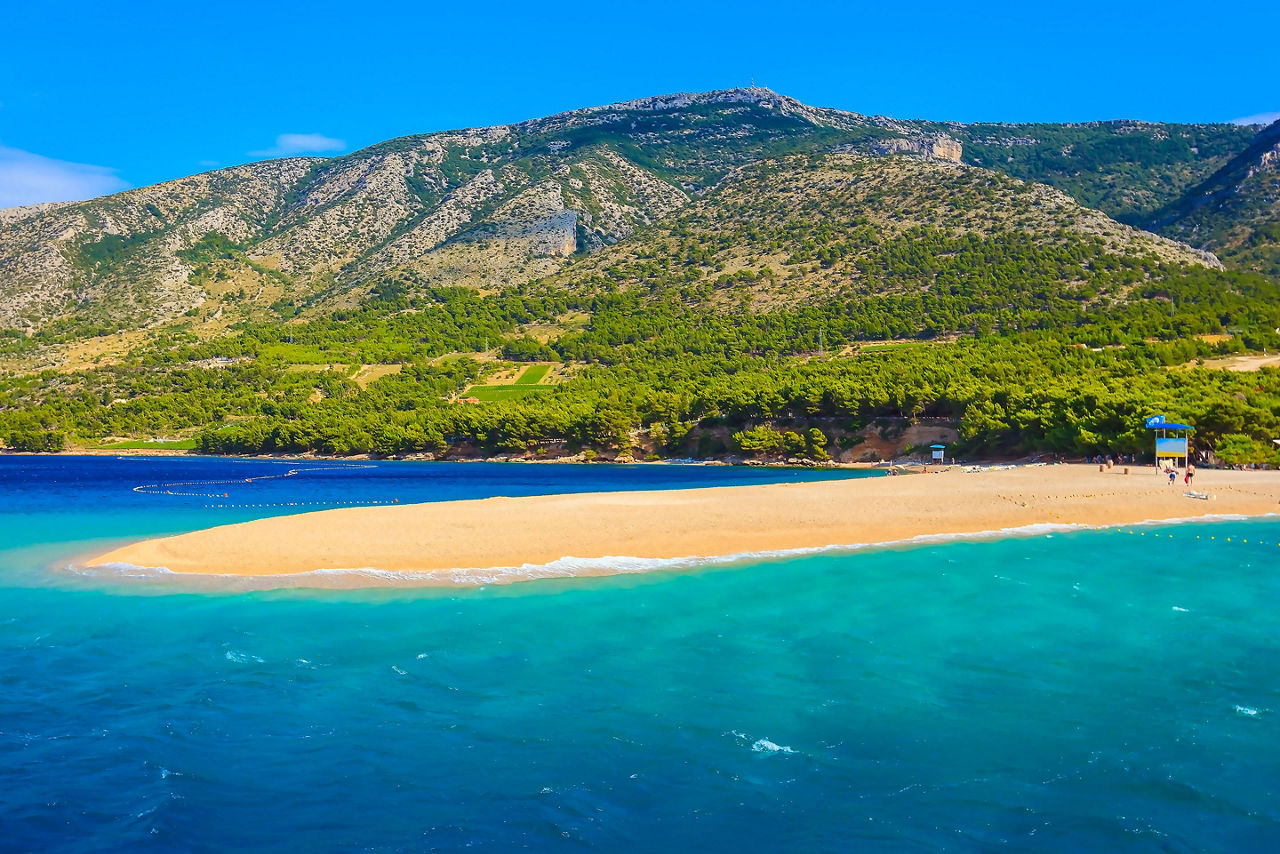 Croatia Zlatni Rat Beach with Mountains in the Background